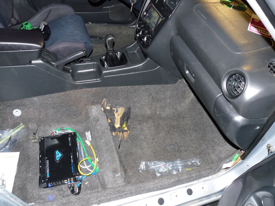 Car interior with Soundstream amplifier on the floor