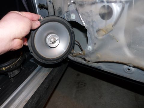 2006 Ford E350 - Removing a car door speaker from its mounting bracket inside the door panel.