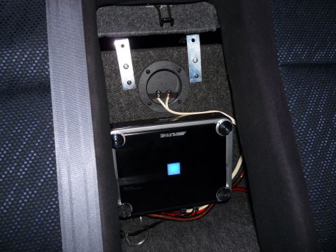 2006 Ford E350 - Close-up of an Alpine amplifier and speaker wiring, installed in a vehicle's interior.