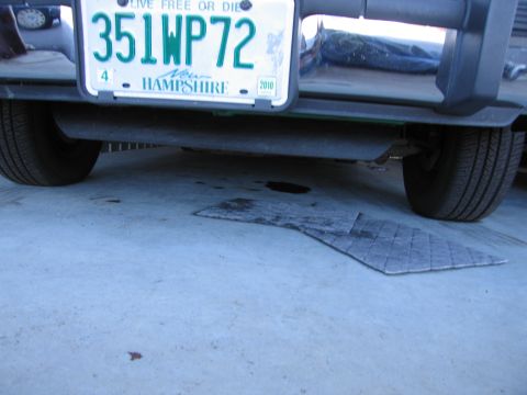 1991 Ford Crown Victoria LTD - The rear of a vehicle is shown, a New Hampshire license plate and a portion of its tire.