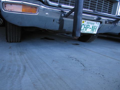 1991 Ford LTD Crown Victoria - Close-up of a car's front end, showing the bumper, tire, and license plate.