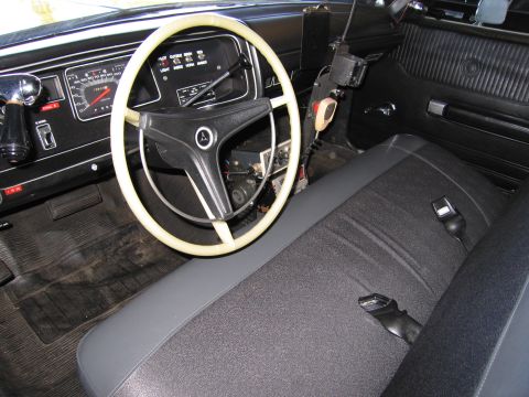 1991 Ford LTD Crown Victoria - Interior view of a car, a steering wheel, dashboard gauges, and a two-tone seat with seatbelts.