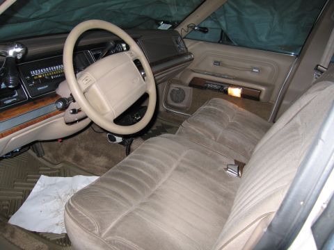 1991 Ford LTD Crown Victoria - Interior of a 1991 Ford Crown Victoria LTD, its dashboard, steering wheel, and plush seating.