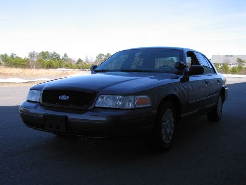 1991 Ford LTD Crown Victoria - Dark Ford Crown Victoria sedan parked outdoors under a clear sky.