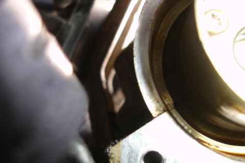 1995 Ford Taurus - This is a close-up view of an engine part, likely a seal or gasket area, showing signs of oil.