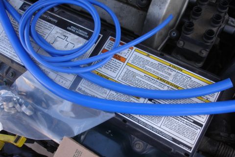 1995 Ford Taurus - Blue silicone hoses are shown coiled over engine labels and components.