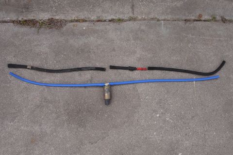 1995 Ford Taurus - A blue silicone hose with a fuel filter is laid out with two black hoses on a concrete surface.