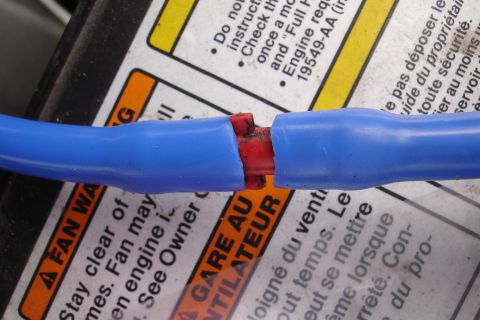 1995 Ford Taurus - Close-up of a damaged electrical connector with wires exposed.