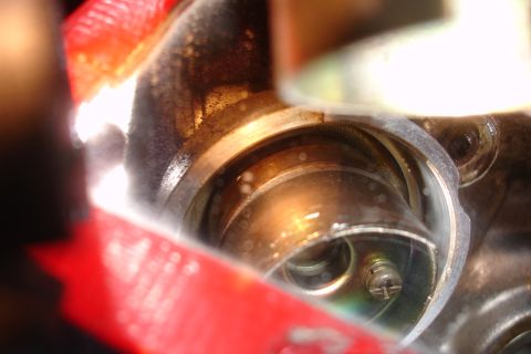 1995 Ford Taurus - Detailed view of an internal engine part, possibly a seal housing, with visible wear and lubricant.