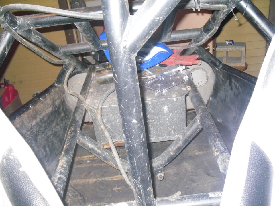 Interior view of a roll cage structure with a fuel tank visible