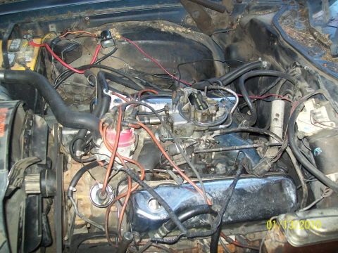 1973 Ford Ranchero - The engine bay is filled with various components and a complex network of wires and hoses.