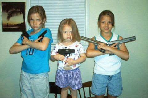 2006 Ford E350 - Three young girls are posing with handguns in a room.