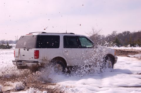 2002 Ford Expedition - White 2002 Ford Expedition splashes through snow and mud during winter off-roading.