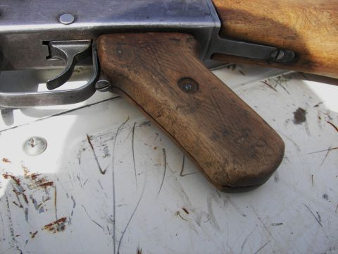 2000 Ford Crown Victoria - Close-up view of a wooden gun grip and its metal trigger mechanism.