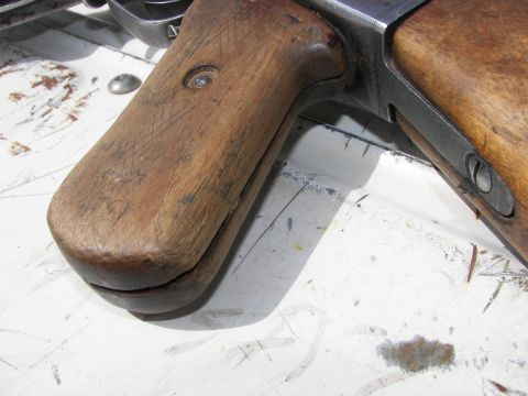 2000 Ford Crown Victoria - Wooden gun stock with visible metal components and wear.