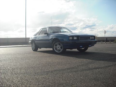 1983 Mercury Capri - This 1983 Mercury Capri 5.0 coupe is seen from a three-quarter front view, parked outdoors on a paved surface.
