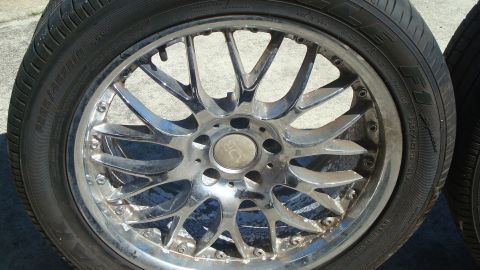 2004 Ford Crown Victoria - A close-up view of a chrome alloy wheel and tire, the 'ADR' logo on the center cap.