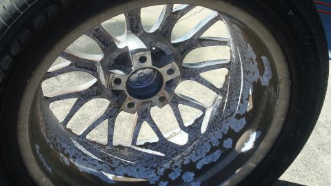 2004 Ford Crown Victoria - Corroded alloy wheel and tire shown in detail.