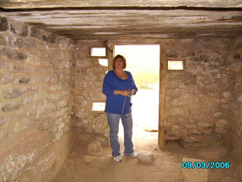 1978 Ford Bronco - A woman stands in a stone structure with small windows and a dirt floor.