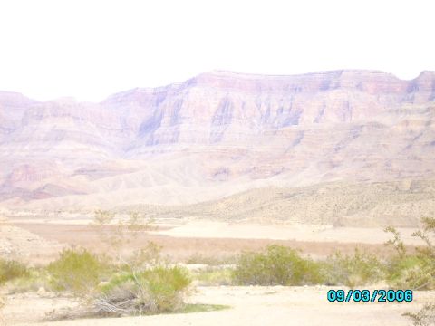 1978 Ford Bronco - A wide desert landscape with layered mountains under a bright sky, sparse vegetation and a date stamp.