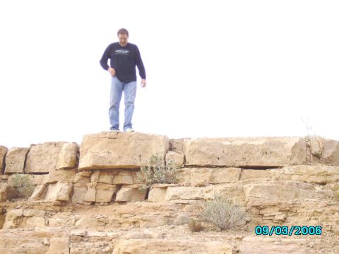 1978 Ford Bronco - A man stands atop a layered rock formation under a bright sky, with a date stamp visible in the lower right corner.