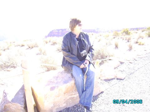 1978 Ford Bronco - A person sits on a large rock in a dry, desert environment, with a camera around their neck. The date 09/04/2006 is visible in the lower ri…