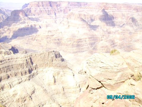 1978 Ford Bronco - A vast canyon landscape under bright sunlight, with layered rock formations stretching into the distance.