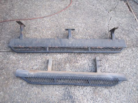 1996 Ford Bronco - Two black metal running boards with diamond plate inserts are shown on a concrete surface.