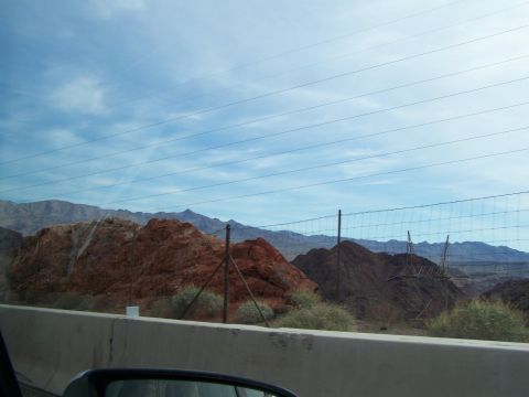 1978 Ford Bronco - View of a desert landscape with mountains and power lines, taken from a vehicle.