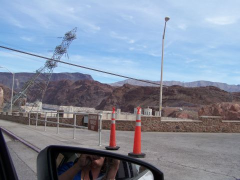 1978 Ford Bronco - A view of the Hoover Dam area, including power lines and surrounding mountains, from inside a vehicle.