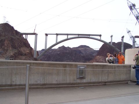 1978 Ford Bronco - Construction of a large bridge spans a canyon, with onlookers observing the progress.