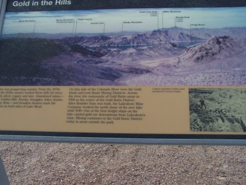 1978 Ford Bronco - A sign displays historical information about gold mining in the hills, accompanied by a panoramic landscape photo.