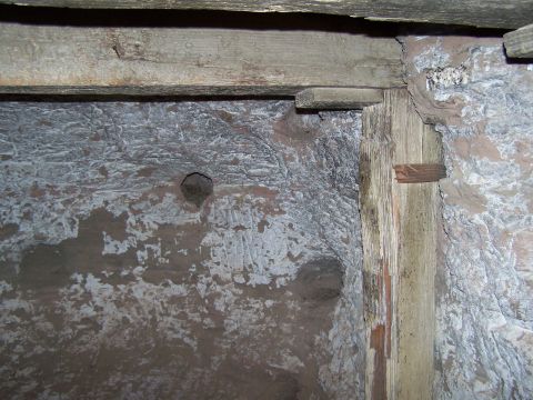 1978 Ford Bronco - Rough stone walls and wooden beams inside a structure, possibly a cellar or old building.