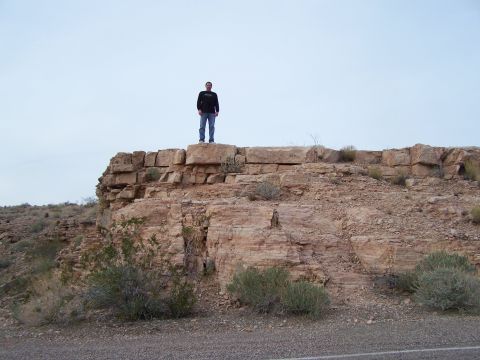 1978 Ford Bronco - A person stands on a rock formation in a desert environment. No vehicles are visible.