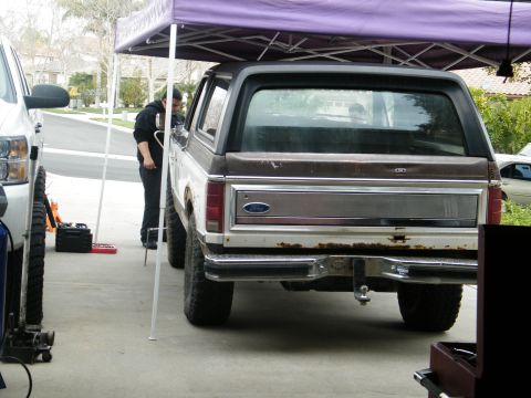 1982 Ford Bronco - A lifted 1982 Ford Bronco is parked under a canopy, with another vehicle to its left.