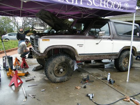 1982 Ford Bronco - A 1982 Ford Bronco is undergoing maintenance with its hood open and tools scattered around.