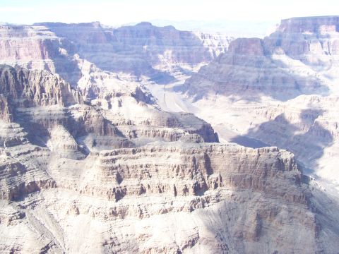 1978 Ford Bronco - A vast expanse of the Grand Canyon unfolds, its dramatic geological layers under a bright sky.
