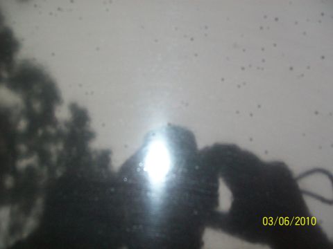 1972 Ford Ranchero - Reflection on a car's surface shows trees and a person, with a date stamp and website visible.