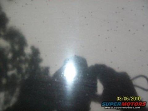 1972 Ford Ranchero - A reflection on a dark surface shows trees and a bright light, with a date stamp of 03/06/2010 and Supermotors.net logo.
