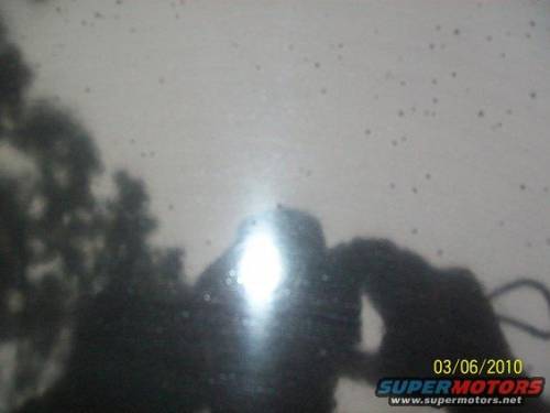 Reflection on dark surface with date stamp
