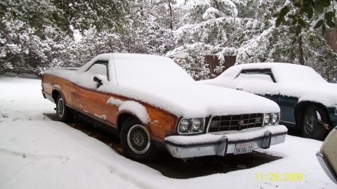 1973 Ford Ranchero - A 1972 Ford Ranchero sits covered in snow next to another vehicle.