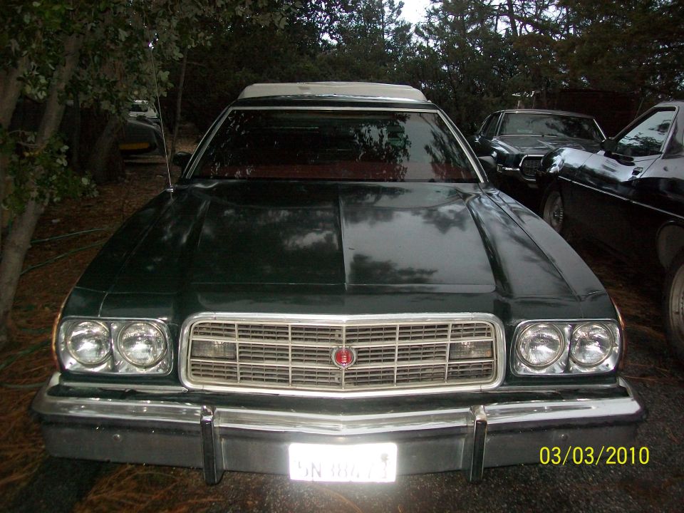 Dark green 1973 Ford Ranchero front view, chrome grille, dual headlights, white license plate