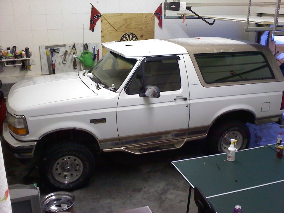 White Ford Bronco parked inside a garage