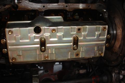 1993 Ford Taurus - Close-up view of an engine's oil pan, showing its bolted construction.