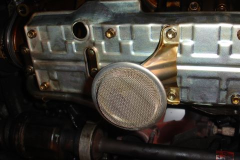 1993 Ford Taurus - The oil pan screen is visible, attached to the engine's metal casing.