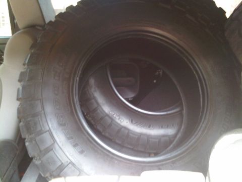 2008 Jeep Wrangler - Spare tire with "BFGOODRICH" text visible, stored inside a vehicle.