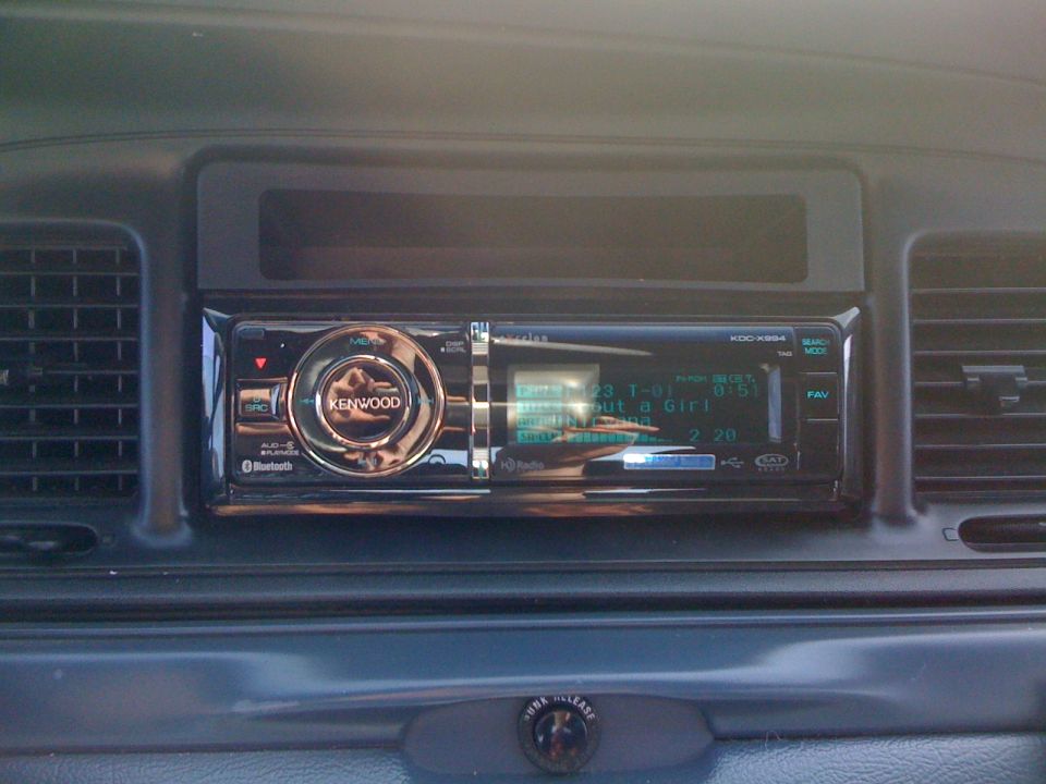 Kenwood KDC-X994 CD receiver installed in a gray dashboard between vertical vents