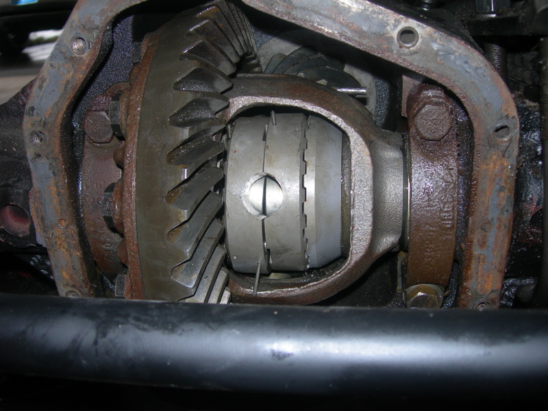close-up of differential gears inside a rusty housing