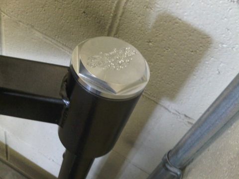 1996 Ford Bronco - Close-up of an engraved aluminum cap on a black cylindrical component.