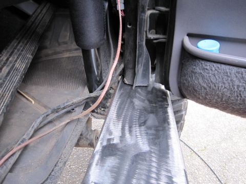 1996 Ford Bronco - Close-up of the interior door sill and wiring, showing a blue cap in the door pocket.